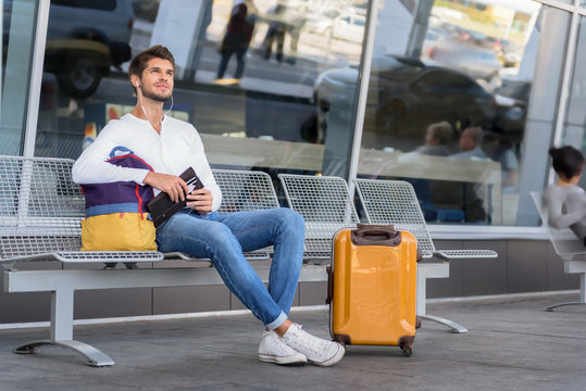 Cheerful young guy preparing for trip
