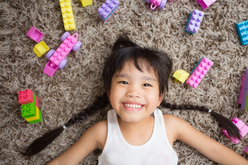 Happy little girl  playing with toy blocks . Kids playing. Child and toys