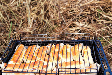 Grilling Sausages on barbecue grill