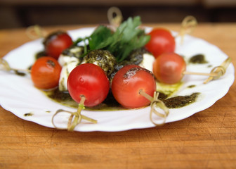 Caprese salad tomato and mozzarella with parsley and herbs on a
