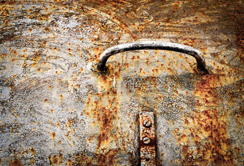 Handle on the old rusty iron hatch