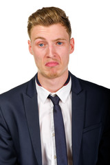 Disgusted young business man wearing suit isolated on white portrait