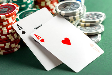 Cards and chips for poker on green table