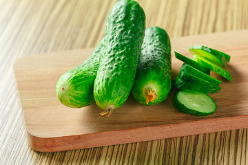  cucumbers on wooden background