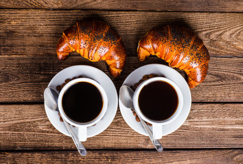 Breakfast with coffee and croissants on table