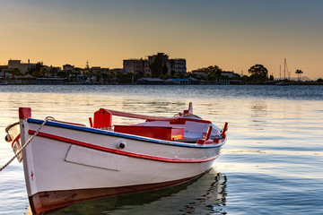 Fototapeta premium Lonely boat in the sunrise 