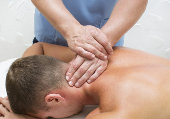 Obraz na płótnie Canvas young man on wellness treatments sports massage