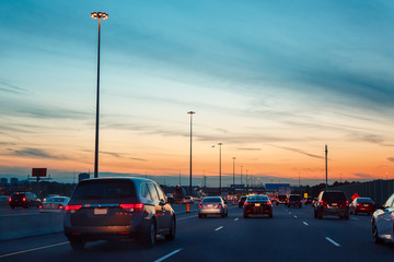 Night traffic, cars on highway road on sunset evening night in busy city, urban view, toned with...