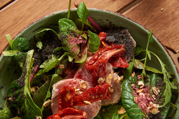 food background of Green beans and tomato salad on dark stone plate
