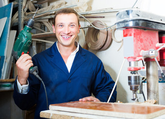 man in uniform choosing compressed densified wood