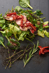 food background of Green beans and tomato salad on dark stone plate