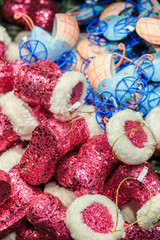 Fototapeta na wymiar Colorful close up details of christmas fair market. Felt boots balls decorations for sales.