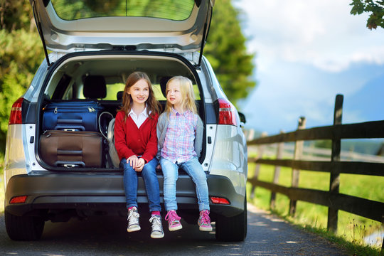 Two Adorable Little Sitting In A Car Before Going On Vacations With Their Parents