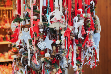 Colorful close up details of christmas fair market. Stars, hearts, tree, fir-cone balls decorations for sales.