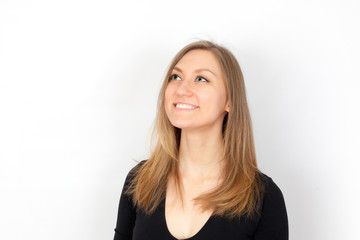 Fototapeta premium Young woman looking up and smiling