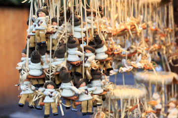 Colorful close up details of christmas fair market. Knited puppet balls decorations for sales.