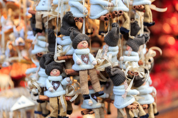 Colorful close up details of christmas fair market. Knited puppet balls decorations for sales.