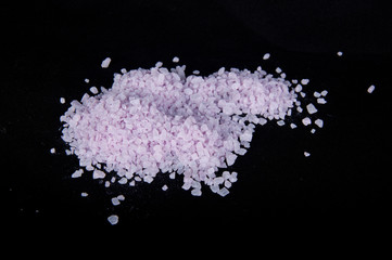Purple sea salt on black background