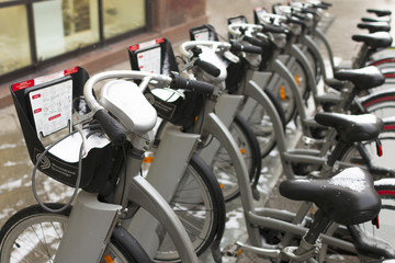 The row of city bikes for rent on a snowy day