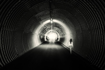 Long dark tunnel, circle form. Light at the end.