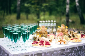 Fotobehang Wedding buffet outdoors with champagne, tartlets, canapés and snacks © marinafedosova