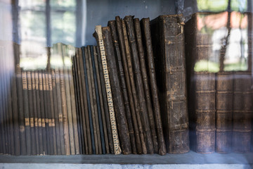 historic old books in library, wooden bookshelf