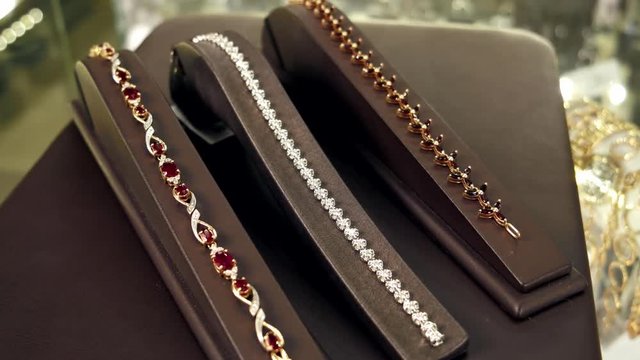 jewelry, bracelet with diamonds, Precious metals and stones turned into jewelry for sale, Jewelry store, Jewels Market - the seller shows gold jewelry earrings, rings, bracelets, chain