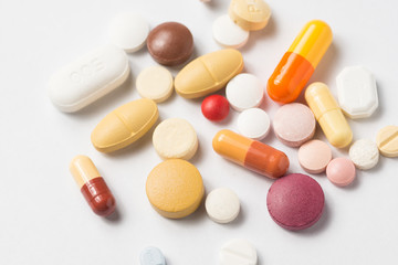 Multiple pills depicting medical treatment or pahrmaceutical ind