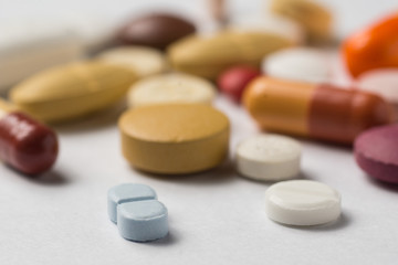 Multiple pills depicting medical treatment or pahrmaceutical ind
