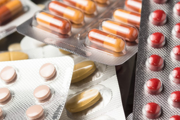 Multiple pills depicting medical treatment or pahrmaceutical ind