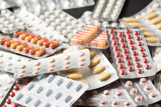 Multiple pills depicting medical treatment or pahrmaceutical ind