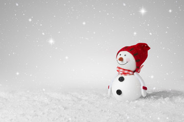 Snow falling on a White Christmas decoration snowman