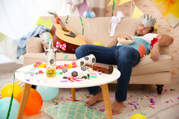 Tired drunk man after party at home