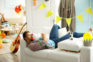 Tired drunk man after party at home