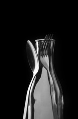 fork and spoon isolated on black background