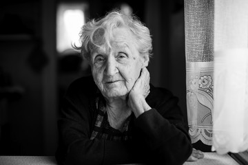 An elderly woman, black-and-white portrait.