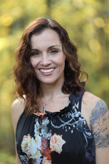 Woman with Brown Hair Against a Fall Background