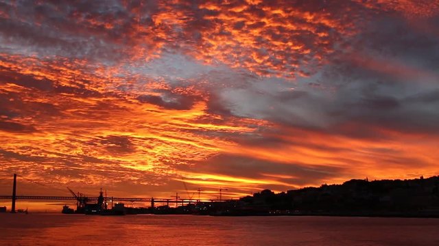 amazing golden sunset over Tagus river fron a boat Lisbon