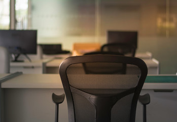 Soft focus and  Low key Black chair on blurred background modern office in morning day