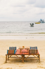 Beach chair and umbrella on sand beach