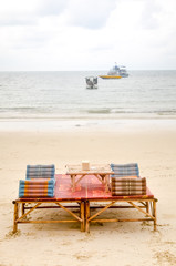 Beach chair and umbrella on sand beach