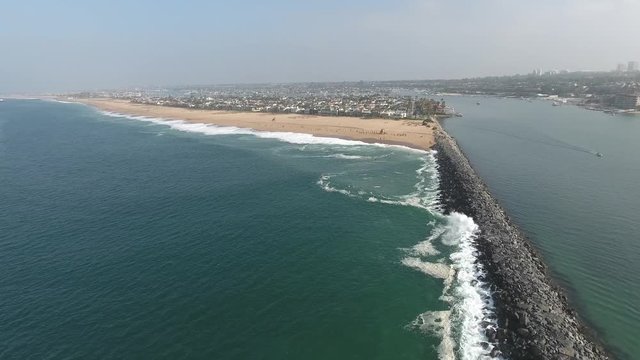 Aerial of Newport Beach, California Jetty  moving toward the wedge during high surf
