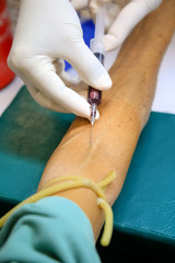 Shot of human hands making an injection with a syringe