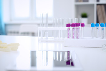 Research laboratory working space. Test tubes and tablet PC are lying at the table. Medical equipment. Blood test