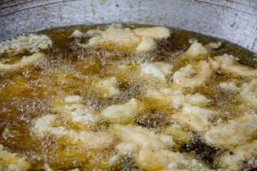 Sweetened fried banana fritters in hot oil, Thailand dessert