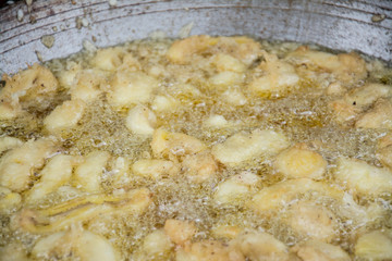 Sweetened fried banana fritters in hot oil, Thailand dessert