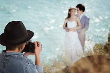 wedding photographer in action, attractive young woman shooting pictures wedding. behind the scenes.