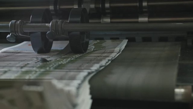 Printing Process on polygraph industry - brochures moving on the conveyor belt, extremely close up