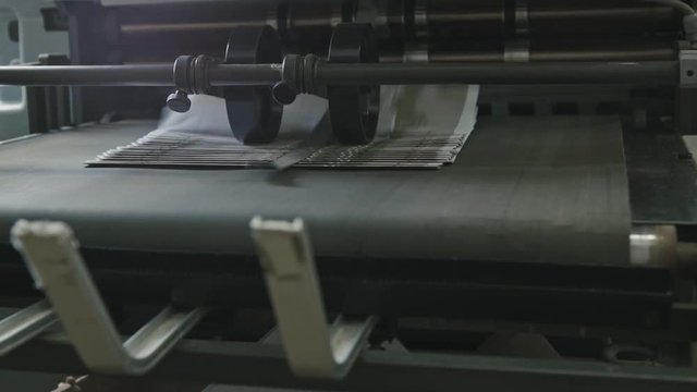 Printing Process on polygraph industry - brochures moving on the conveyor belt, slider
