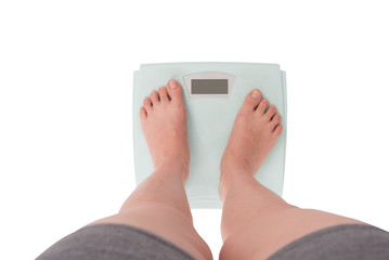 Young Woman Standing On Weighing Digital isolated on white background. Top View